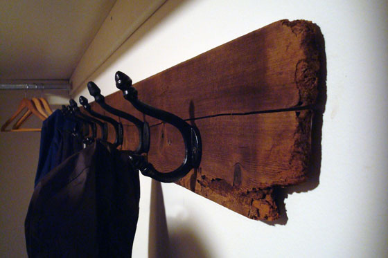 Wrought iron hooks on a barn board backer