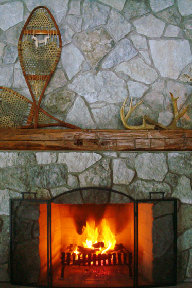 Fieldstone fireplace with barn beam mantel