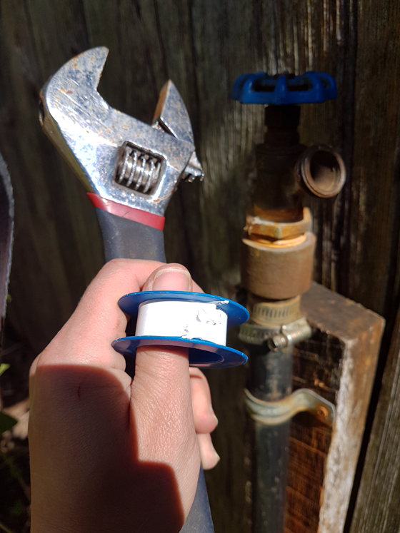Using teflon tape and an adjustable wrench to prevent a leaky garden hose